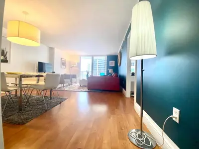a living room with a table and a floor lamp at 1BR Brickell included Pool, Gym and Free Parking in Miami