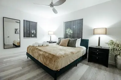 a bedroom with a large bed and a ceiling fan at Miami Palms Serene in Miami