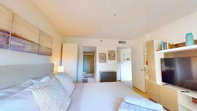 a living room with a couch and a television at Modern Luxury Condo Near Beach & Aventura Mall in Aventura