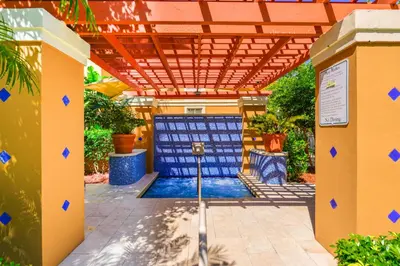 a garage with a blue door and a pool at Modern Luxury Condo Near Beach & Aventura Mall in Aventura