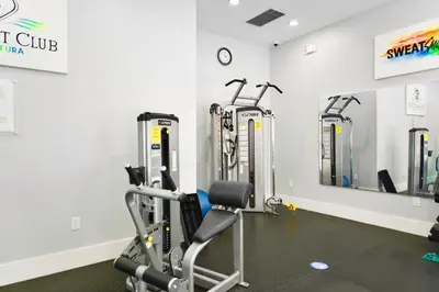a gym with cardio equipment in a room at Modern Luxury Condo Near Beach & Aventura Mall in Aventura