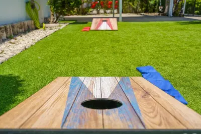a wooden table in the grass with a playground at Miami 3BR Cruise Port Calle 8 Brickell South Beach in Miami