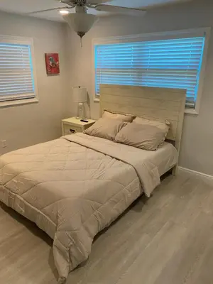 a bedroom with a large bed and a window at Private Room in Spacious 3-Bedroom Home in Fort Lauderdale