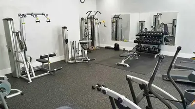 a gym with a bunch of equipment in a room at Yacht Club Aventura 2 BR 2 Bath with Free Parking in Aventura