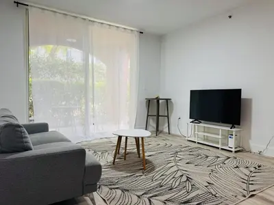 a living room with a couch and a tv at Yacht Club Aventura 2 BR 2 Bath with Free Parking in Aventura