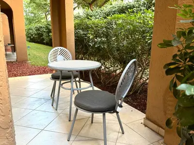 two chairs and a table and a table and chairs at Yacht Club Aventura 2 BR 2 Bath with Free Parking in Aventura