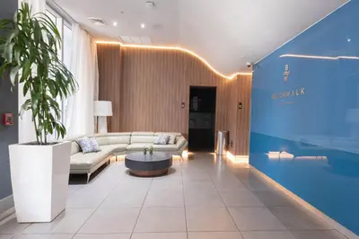a living room with a couch and a table at Studio 2 beds queen, pool, gym and service beach in Hallandale Beach