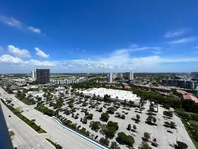 an aerial view of a city with a parking lot at Studio 2 beds queen, pool, gym and service beach in Hallandale Beach