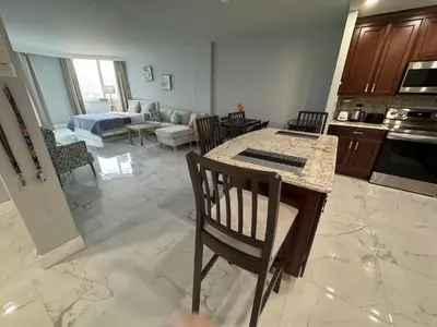 a kitchen and living room with a table and chairs at Modern Apartments Ocean Reserve Sunny Isles Beach in Sunny Isles Beach