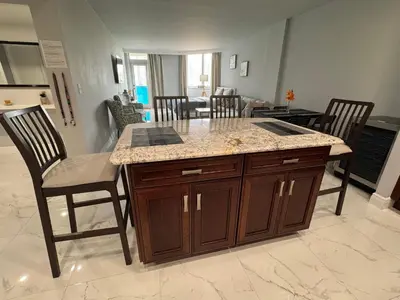 a kitchen with a counter and a table and chairs at Modern Apartments Ocean Reserve Sunny Isles Beach in Sunny Isles Beach
