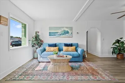 a living room with a blue couch and a table at 4BR Escape Near Beach & Downtown in Fort Lauderdale