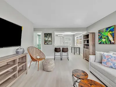 a living room with a couch and a flat screen tv at North Hollywood Beach 1BR | Walk to Ocean in Dania Beach