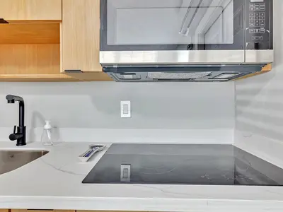 a kitchen with a sink and a microwave at North Hollywood Beach 1BR | Walk to Ocean in Dania Beach