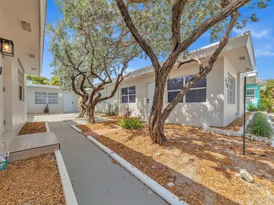 a house with trees in the front of it at North Hollywood Beach 1BR | Walk to Ocean in Dania Beach