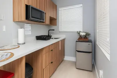 a kitchen with a counter with a tv and a refrigerator at Hollywood Beach 1BR | Steps to Dania Beach in Dania Beach