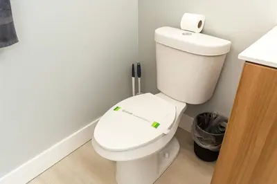 a bathroom with a toilet with a sticker on it at Hollywood Beach 1BR | Steps to Dania Beach in Dania Beach