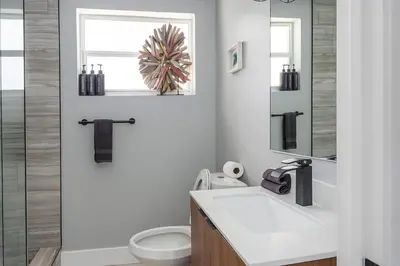 a bathroom with a sink and a toilet and a mirror at Hollywood Beach 1BR | Steps to Dania Beach in Dania Beach