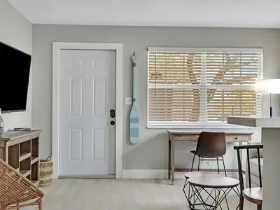 a room with a door and a desk and a window at Hollywood Beach 1BR Getaway | WiFi + AC in Dania Beach