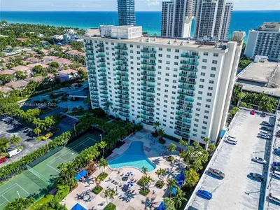 an aerial view of a large building with a tennis court at Ocean Reserve Luxury Condo Sunny Isles Beach in Sunny Isles Beach