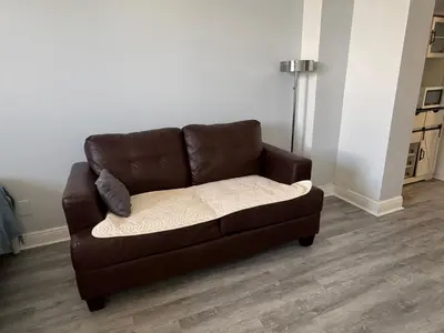 a brown couch sitting in a living room at Ocean Reserve Luxury Condo Sunny Isles Beach in Sunny Isles Beach
