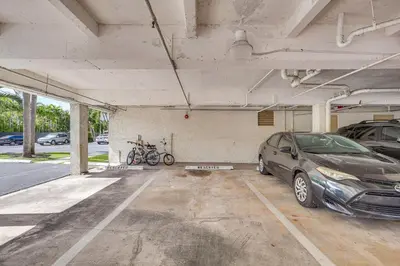 a parking garage with two cars parked in it at Sunny isles Escape-1BR Condo Steps from the Beach! in Sunny Isles Beach