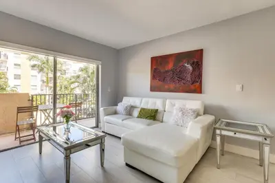 a living room with a white couch and a table at Sunny isles Escape-1BR Condo Steps from the Beach! in Sunny Isles Beach