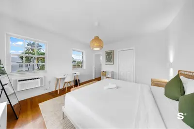 a white bedroom with a bed and a table at Modern 1-BD Apt with Free Parking in Miami Beach