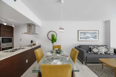 a kitchen and living room with a table and a couch at Luxury Miami Condo with Breathtaking City & Bay Views in Miami
