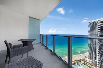 a balcony with a table and a view of the ocean at Beachfront Bliss W Ocean Views in Hollywood