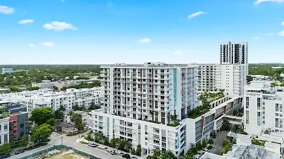 an aerial view of a large white apartment building at Chic Ft Lauderdale 2BR | Pool + Nightlife in Fort Lauderdale