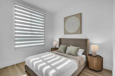 a white bedroom with a bed and a window at #206 Brand-New 2BR- 2BA Near Brickell in Miami