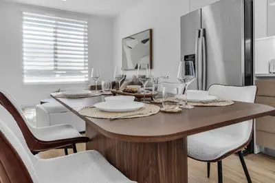 a dining room with a wooden table and chairs at #207 brand new 2BR 2BA near brickell and stadium Central location in Miami
