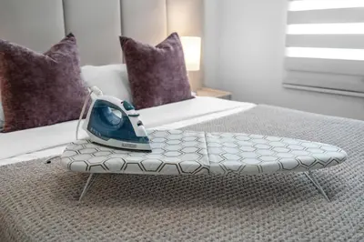 a vase sitting on top of a bench on a bed at #208 Brand New 2BR -2BA near marlins stadium in Miami