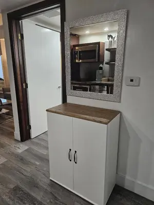 a kitchen with a mirror and a white cabinet at Big studio with rooftop pool ocean view in Miami Beach