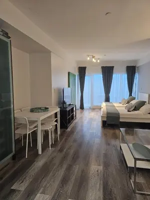 a bedroom with a bed and a desk and a table at Big studio with rooftop pool ocean view in Miami Beach
