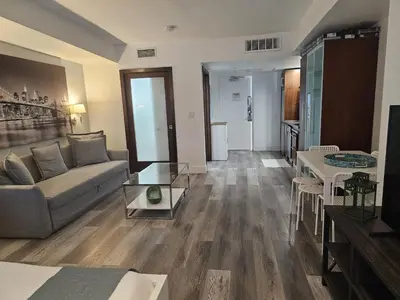 a living room with a couch and a table at Big studio with rooftop pool ocean view in Miami Beach