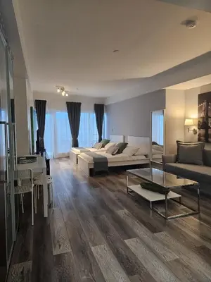 a living room with a couch and a table at Big studio with rooftop pool ocean view in Miami Beach