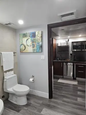 a bathroom with a toilet and a kitchen at Big studio with rooftop pool ocean view in Miami Beach
