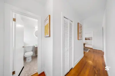 a bathroom with white walls and a toilet at Spacious 1BD Beachside Apt with Free Parking in Miami Beach