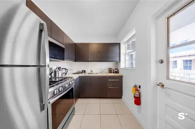 a kitchen with a refrigerator and a stove at Modern 1-BD Beachside Apt with Free Parking in Miami Beach