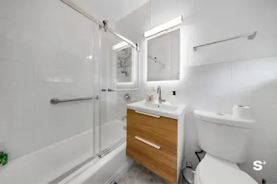 a bathroom with a shower and a toilet and a sink at Modern 1-BD Beachside Apt with Free Parking in Miami Beach