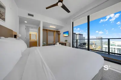 a bedroom with a large white bed and a large window at 2-BD Downtown Miami Condo with City Views in Miami