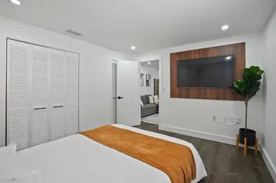 a bedroom with a bed and a flat screen tv at Luxury 1 bedroom apt in Kendall Prime Location in Westwood Lake