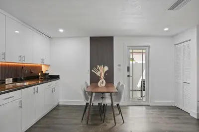 a kitchen with white cabinets and a table with a vase on it at Luxury 1 bedroom apt in Kendall Prime Location in Westwood Lake