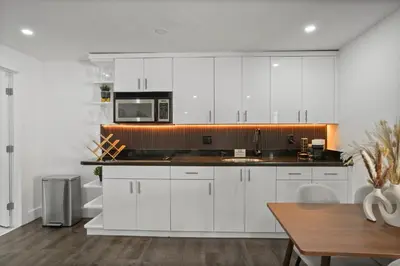 a kitchen with white cabinets and a microwave at Luxury 1 bedroom apt in Kendall Prime Location in Westwood Lake