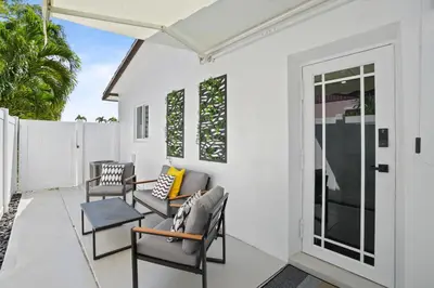 a patio with chairs and an umbrella at Luxury 1 bedroom apt in Kendall Prime Location in Westwood Lake