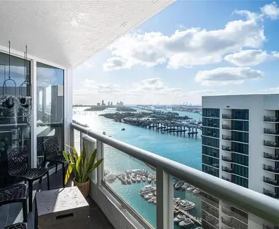 a balcony with a view of a harbor at Luxury 3-Bedroom Bayview Retreat at The Grand Miami in Miami