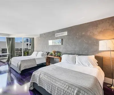 a hotel room with two beds and a balcony at Luxury 3-Bedroom Bayview Retreat at The Grand Miami in Miami