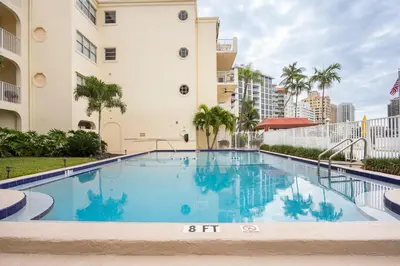 a large swimming pool in front of a building at The Blue Octopus - 1br King Bed Condo in Fort Lauderdale