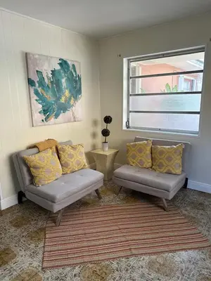 a living room with two couches and a window at Peach Private Room in Miami